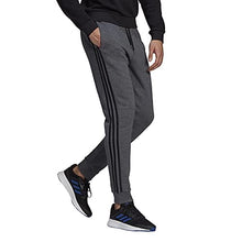 Load image into Gallery viewer, adidas Men&#39;s Standard Essentials Fleece Tapered Cuff 3-Stripes Pants, Dark Grey Heather/Black, X-Small
